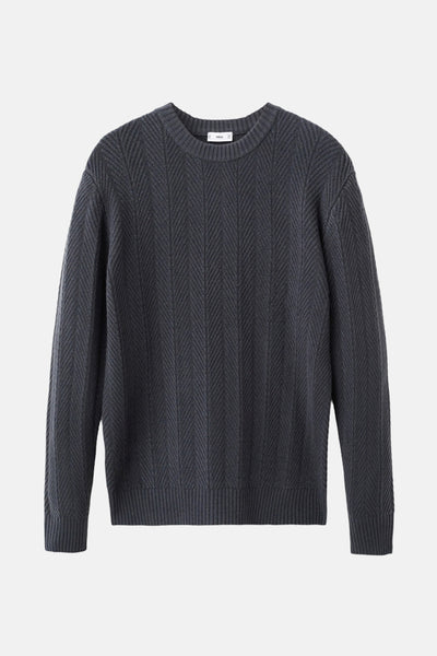 Pull à col rond gris de MANGO, avec motif à chevrons verticaux sur toute la surface.