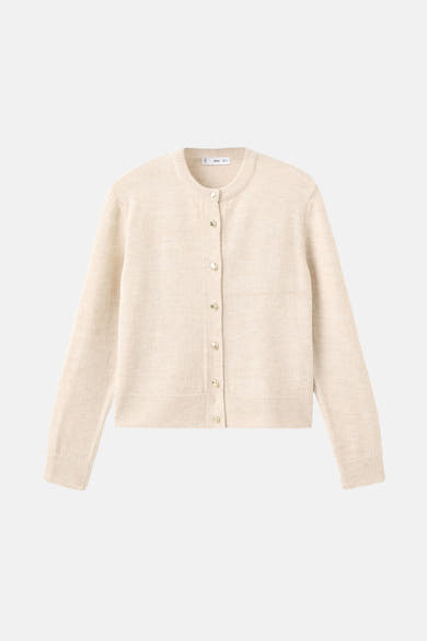 Cardigan en maille blanc cassé de MANGO, avec fermeture boutonnée dorée sur fond uni.