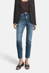 Slim jeans in medium blue denim from MANGO, worn with a blazer and wedge shoes.