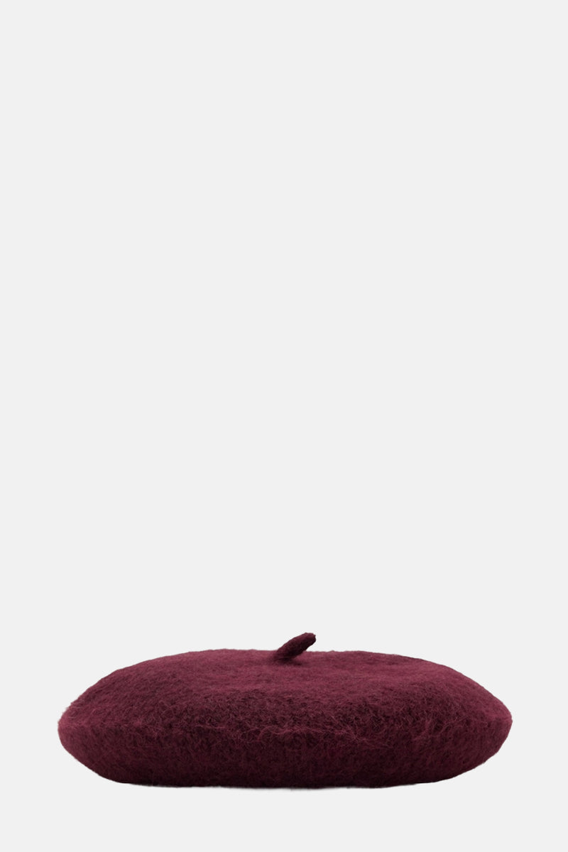 Béret bordeaux in wolwutut door MANGO, met een zachte texture en een ronde vorm.