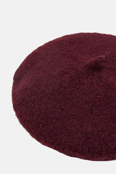 Béret bordeaux en feutre de laine par MANGO, avec une texture douce et une forme ronde.
