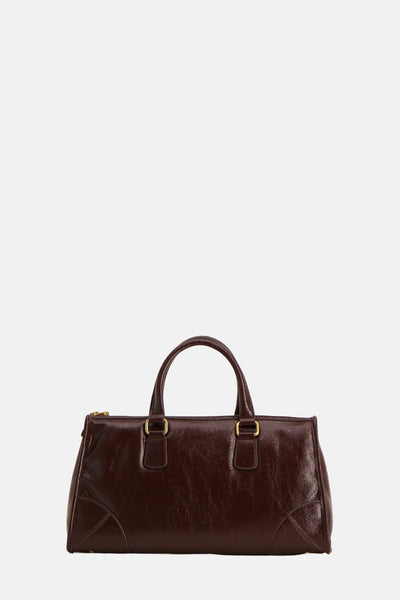 Sac à main brun en cuir by MANGO, avec poignées et détails dorés.
