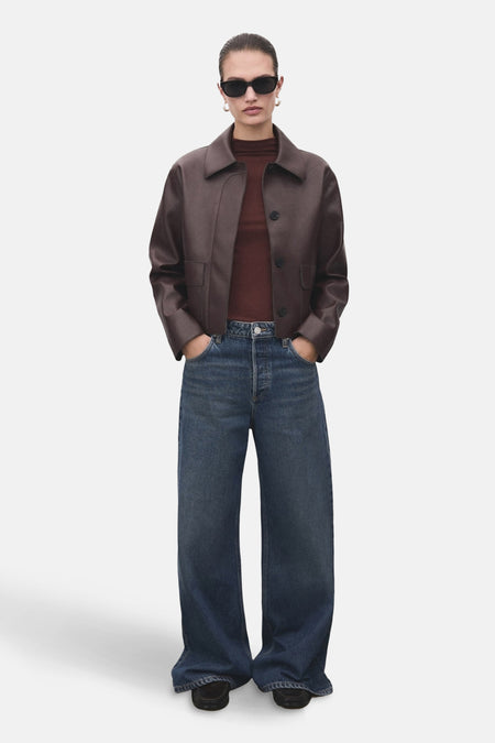 T-shirt à manches longues brun de MANGO, porté avec une veste en cuir et un jean taille haute.
