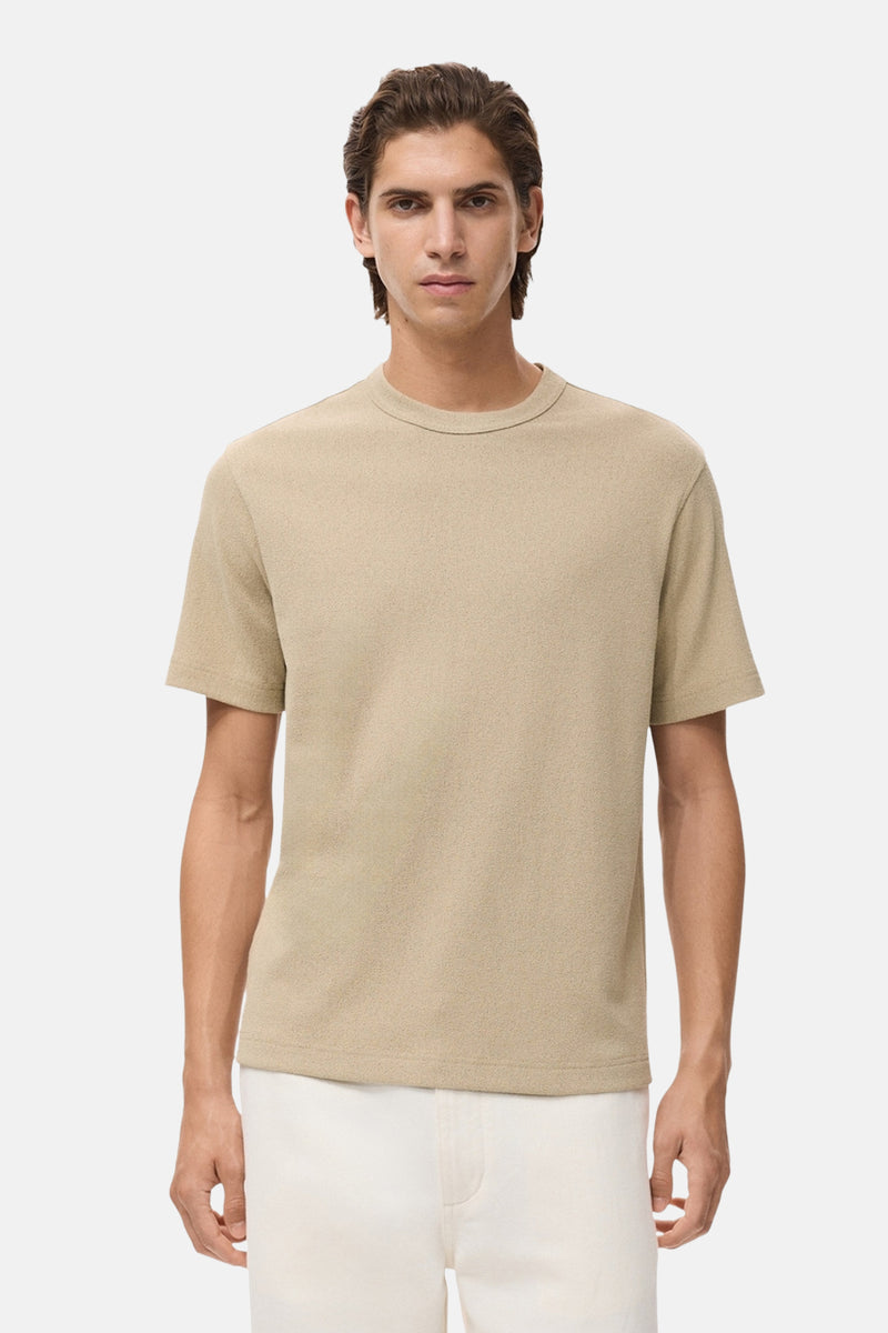 Beige T-shirt met korte mouwen van MANGO, op een paspop met een witte broek.