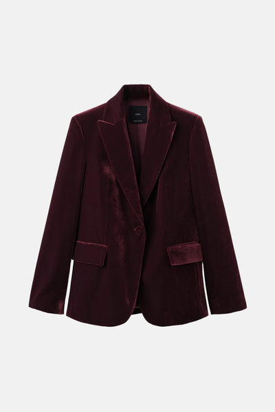 Blazer bordeaux en velours de MANGO, avec un col à revers et des poches passepoilées.