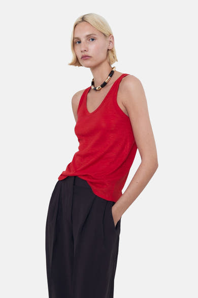 Rood hemdje van MANGO, gedragen met een zwarte broek met hoge taille en een textuurketting.