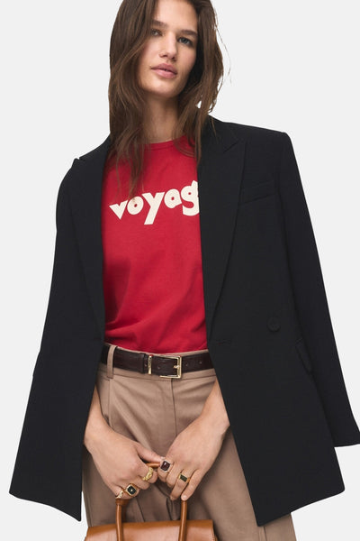 T-shirt rouge à manches courtes de MANGO, porté avec un blazer noir et un pantalon beige.