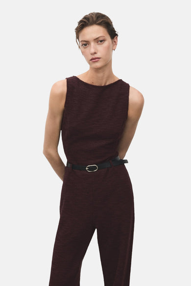 Bordeaux jumpsuit van MANGO, met zwarte riem en rechte pasvorm, gedragen door een model.