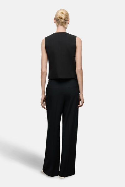 Pantalon noir de MANGO, coupe ample et taille haute, vue de dos.