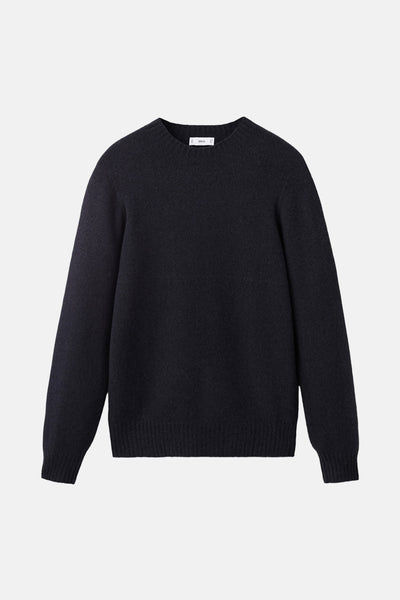 Pull à col rond bleu foncé de MANGO, en maille texturée fine et coupe classique.
