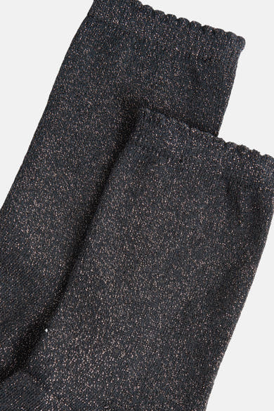 Chaussettes grises scintillantes de PIECES®, détail de texture tricotée avec bords ondulés.