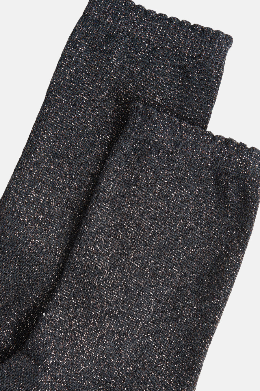Chaussettes grises scintillantes de PIECES®, détail de texture tricotée avec bords ondulés.