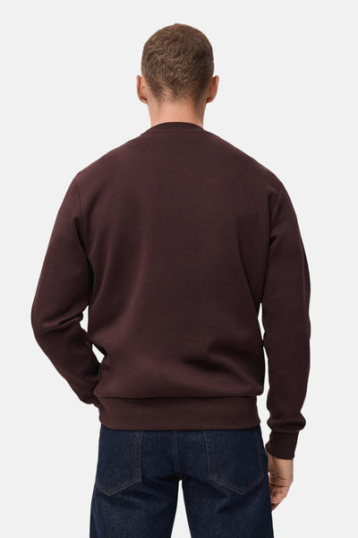 Bruin sweatshirt van MANGO, van achteren gezien, gedragen met een donkerblauwe jeans.