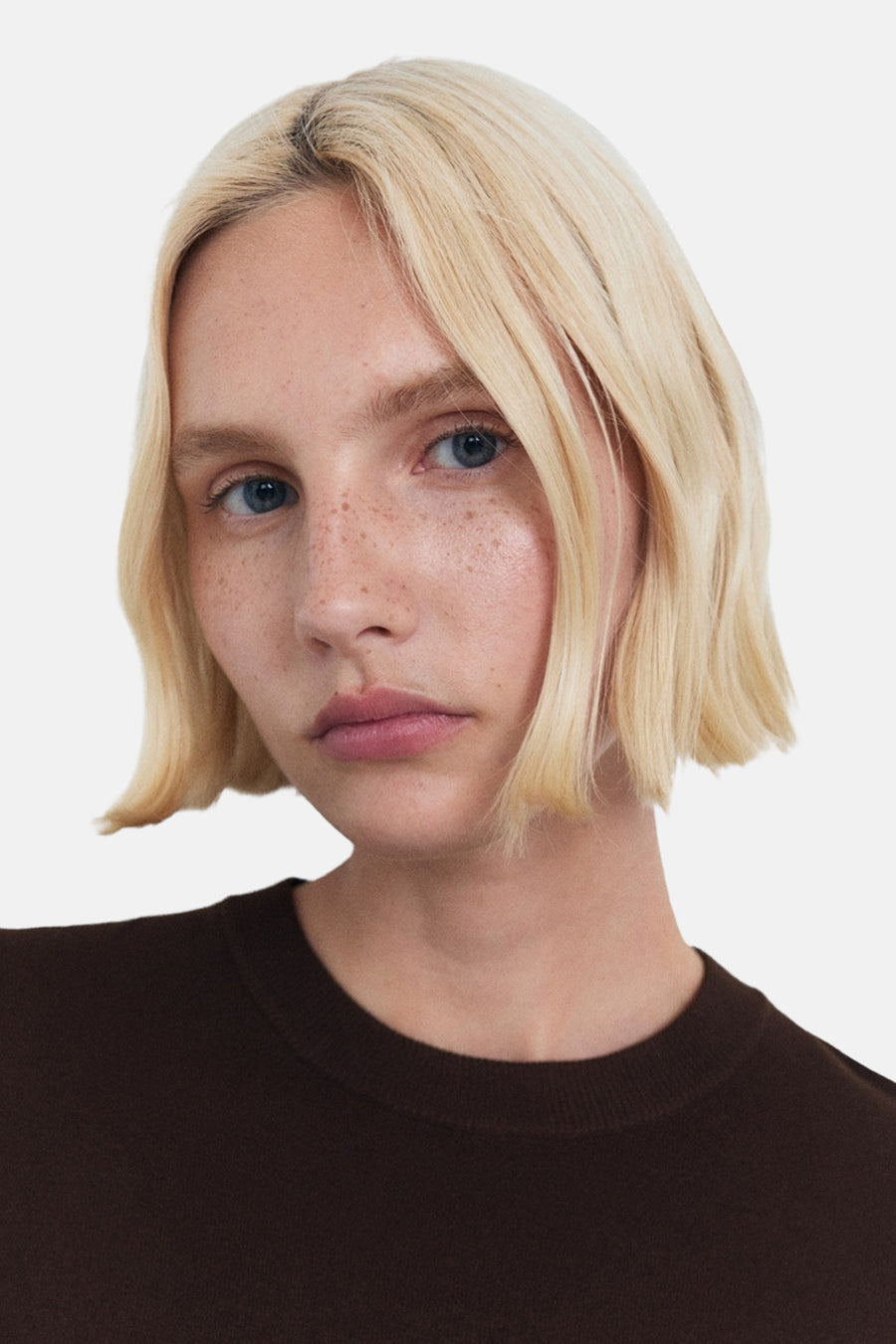 Bruin T-shirt met korte mouwen van MANGO, gedragen door een blonde vrouw met blauwe ogen.