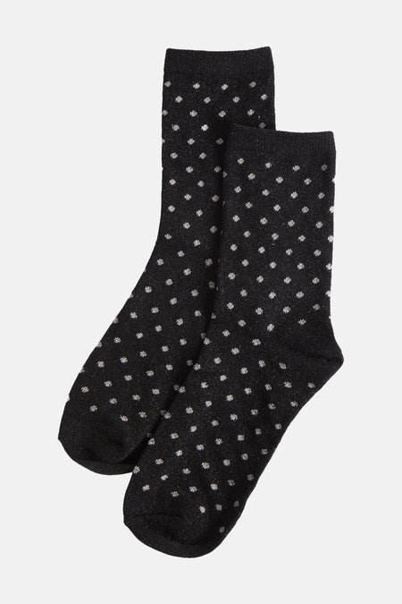 Chaussettes noires à pois scintillants de PIECES®, présentées sur fond uni.