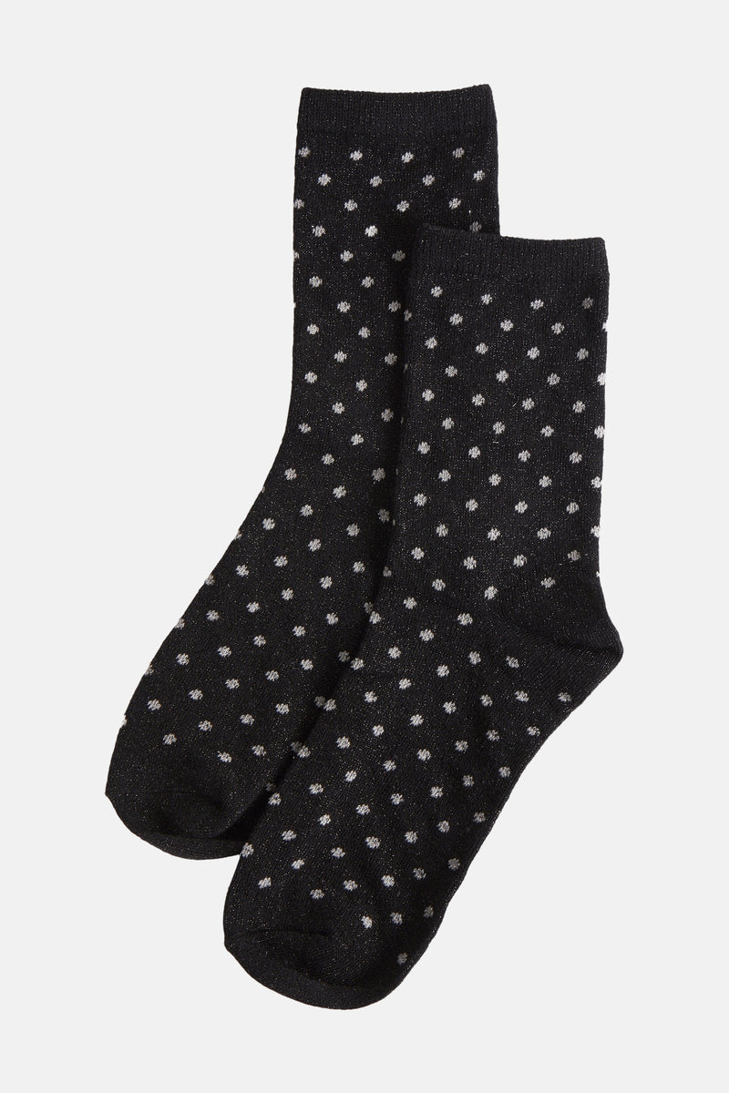 Chaussettes noires à pois scintillants de PIECES®, présentées sur fond uni.
