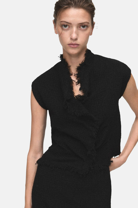 Zwart tweed hemdje van MANGO, met opstaande kraag en gefranjerde zoom, achterzijde.