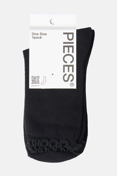 Black ankle socks with ribbed texture and braided toe detail by Pieces, shown on white tag, front view
