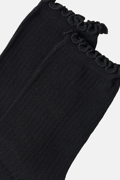 Black ribbed socks with scalloped ruffle trim, close-up side view