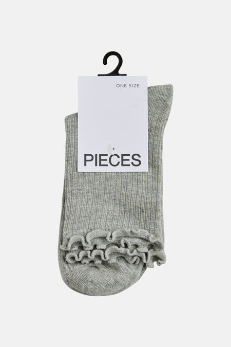 Chaussette gris chiné de PIECES, avec bordure à volants et étiquette de suspension.