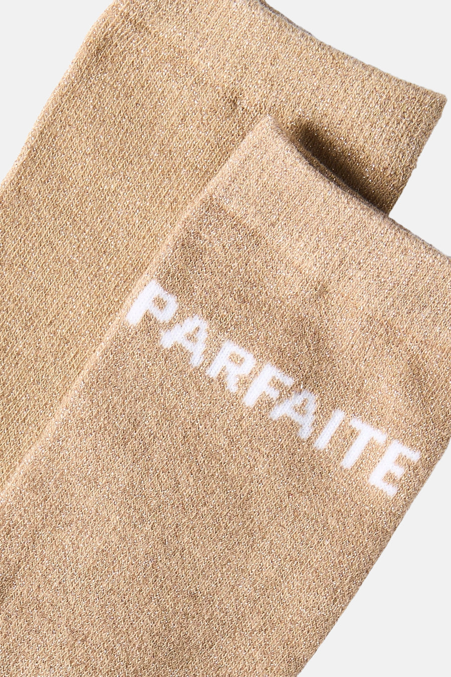 Natural beige socks with white "PARFAITE" text, soft knit texture, close-up view
