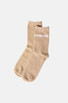 Natural beige crew socks with white "PARFAITE" text on cuff, soft knit texture, flat lay front view