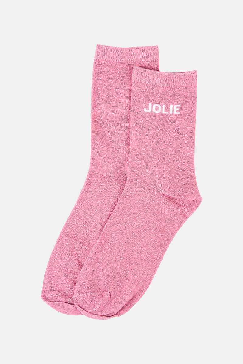 Roze glinsterende sokken van PIECES, met het woord 'MOOI' in het wit, op een effen achtergrond.