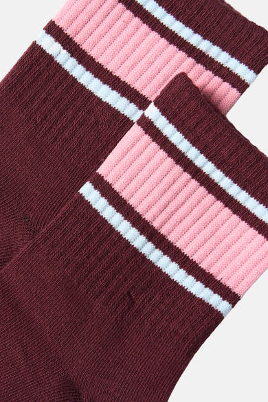 Burgundy socks with pink and white striped ribbed cuff, close-up view showing textured knit fabric