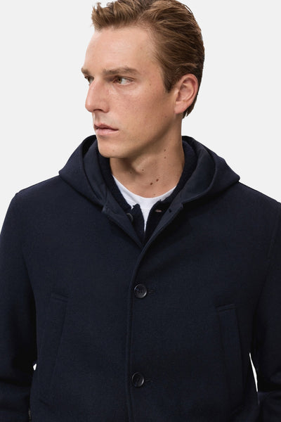 Veste courte bleu foncé de MANGO, avec une capuche et une fermeture à boutons.