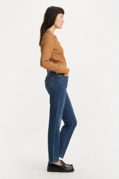 Jean droit bleu de Levi's, porté avec une chemise marron et des mocassins noirs, vue de côté.