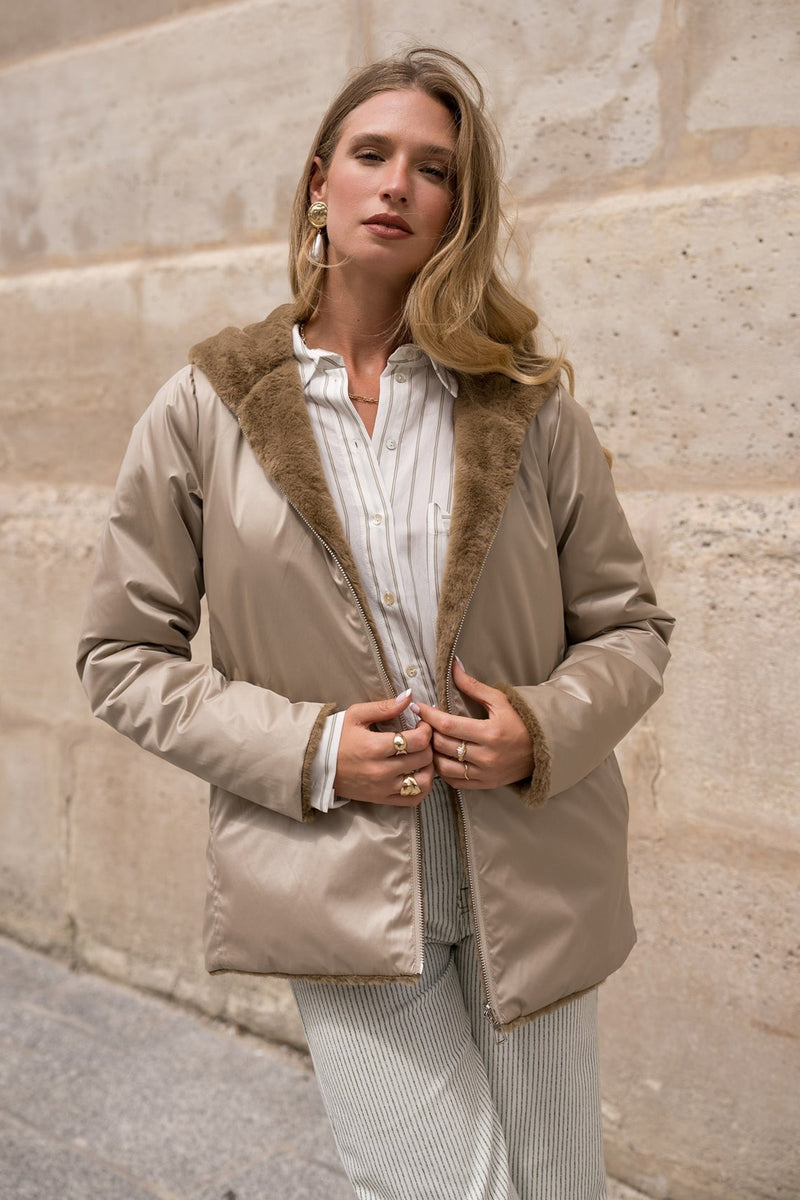 Imperméable beige de LAURA JO avec doublure effet fourrure, porté sur une chemise rayée et un pantalon assorti.