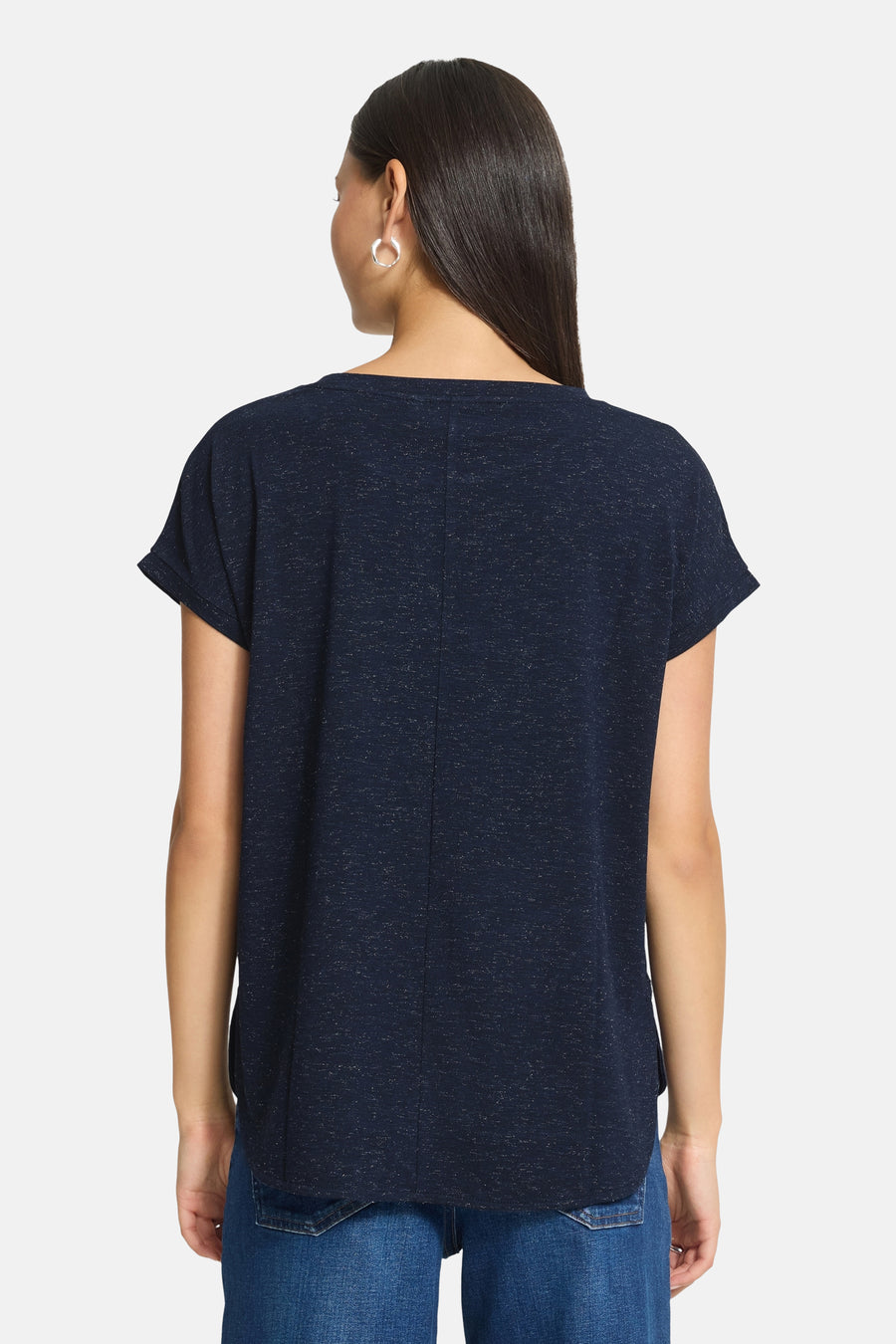 Navy blue short-sleeve t-shirt with subtle speckled texture, back view, worn with jeans and hoop earrings