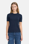 Navy blue short-sleeve ribbed crewneck sweater, front view, worn with dark denim jeans