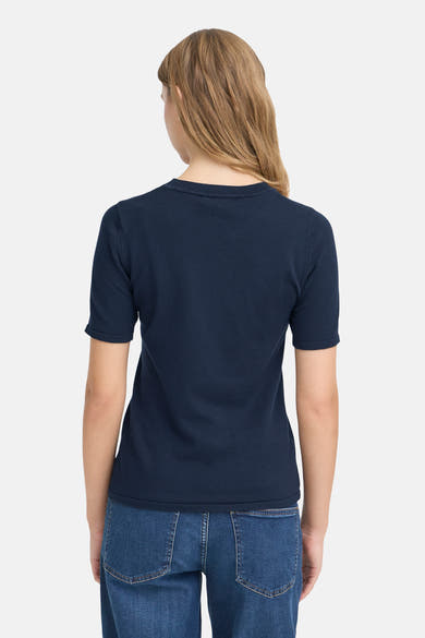 Navy blue short-sleeve crewneck sweater with ribbed texture, back view on model wearing jeans