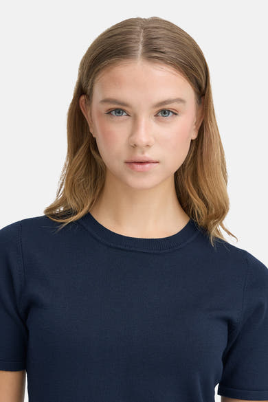 Navy blue short-sleeve crewneck sweater with ribbed texture, front view on model