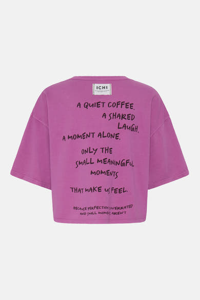 Pink short-sleeve T-shirt by ICHI with black handwritten text print on back, oversized fit, crew neck, and brand label at neckline.
