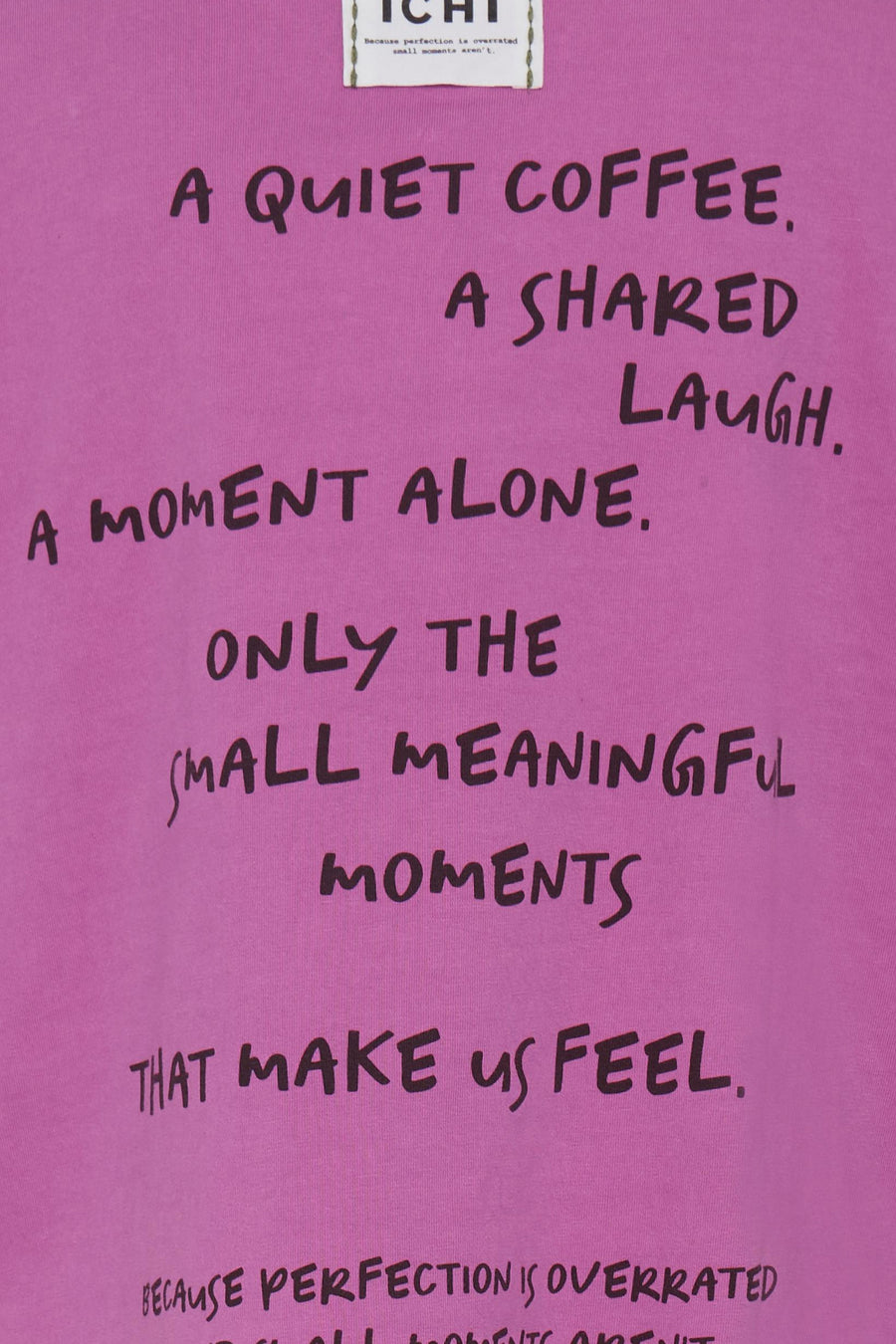 Pink short-sleeve t-shirt with handwritten-style black text, featuring phrases like "A quiet coffee" and "Only the small meaningful moments," close-up front view.