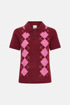 Burgundy knit polo shirt with pink argyle pattern and three-button placket, front view