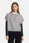 Grey knit short-sleeve polo débardeur by ICHI, featuring ribbed hem and front buttons, worn over black long sleeves with black jeans.