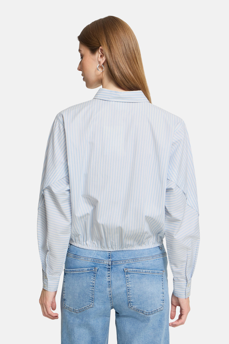 Blue and white striped long-sleeve blouse with gathered waist, back view, paired with light blue jeans