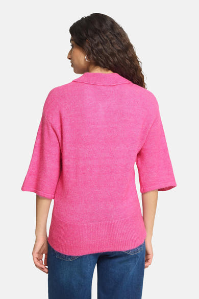 Pink knitted gilet with ribbed collar and hem, back view, worn with blue jeans