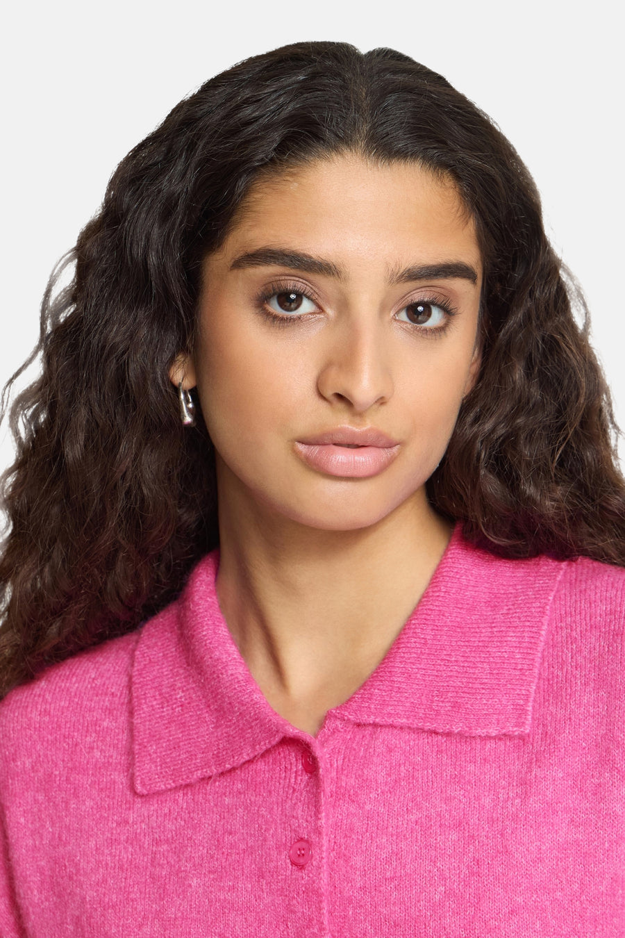 Rose pink knitted gilet with collar and button front, cropped front view on model