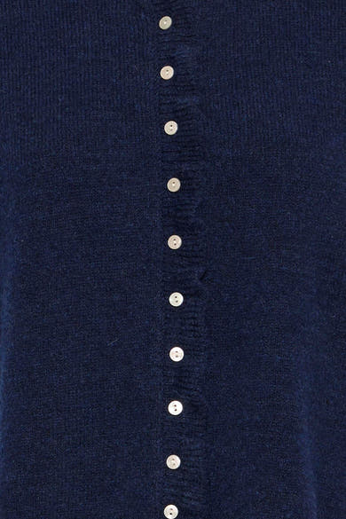 Navy blue sleeveless knit gilet with white buttons down the front, close-up view showing textured fabric and ribbed placket.