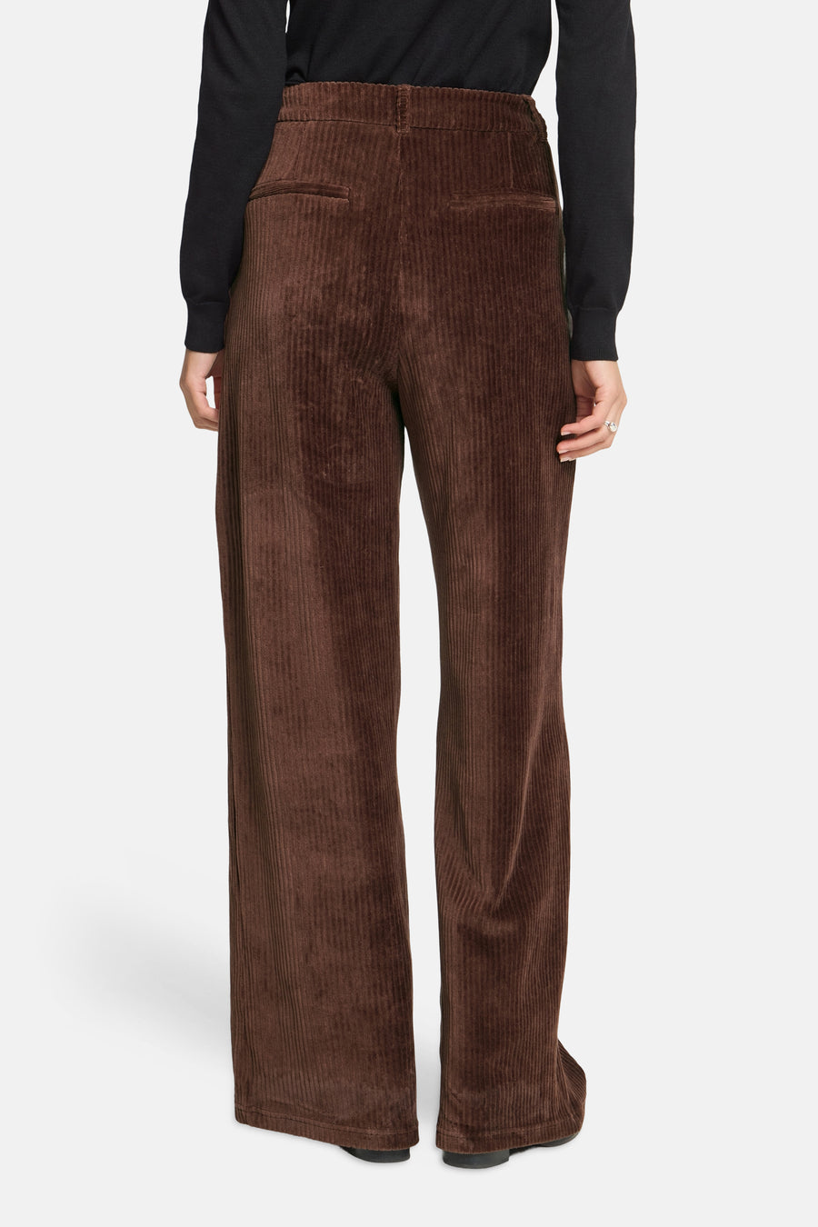 Brown corduroy wide-leg suit pants by ICHI, back view with elastic waistband and ribbed texture, worn with black top.