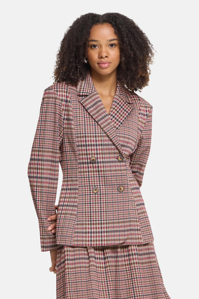 Multicolored plaid double-breasted blazer with structured shoulders and four-button front, worn in a full-length studio shot.