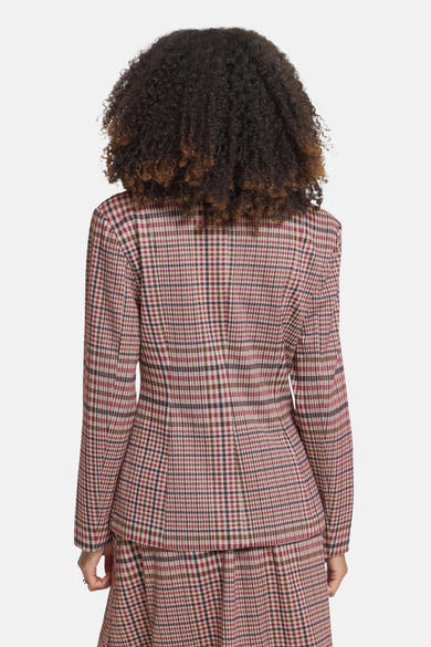 Multicolored plaid blazer back view featuring red, beige, and brown check pattern with structured shoulders and tailored fit on model with curly hair