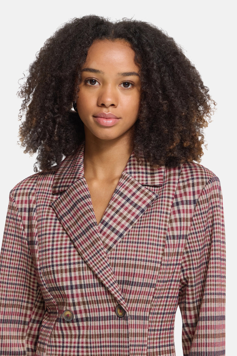 Multicolored plaid blazer with double-breasted design, notched lapels, and two front buttons, worn by model in cropped front view