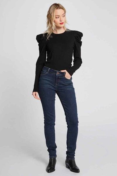 Jean skinny bleu de Morgan de Toi, porté avec un pull noir à manches longues et des bottines noires.
