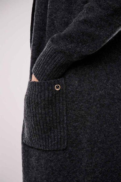 Grey knit gilet with ribbed pocket and gold heart emblem, side view close-up