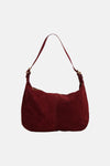 Red suede shoulder bag with gold-tone hardware, front view, soft texture, curved silhouette